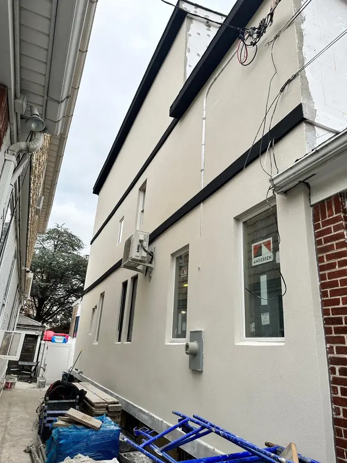 Horizontal banding detail on a Brooklyn stucco side elevation