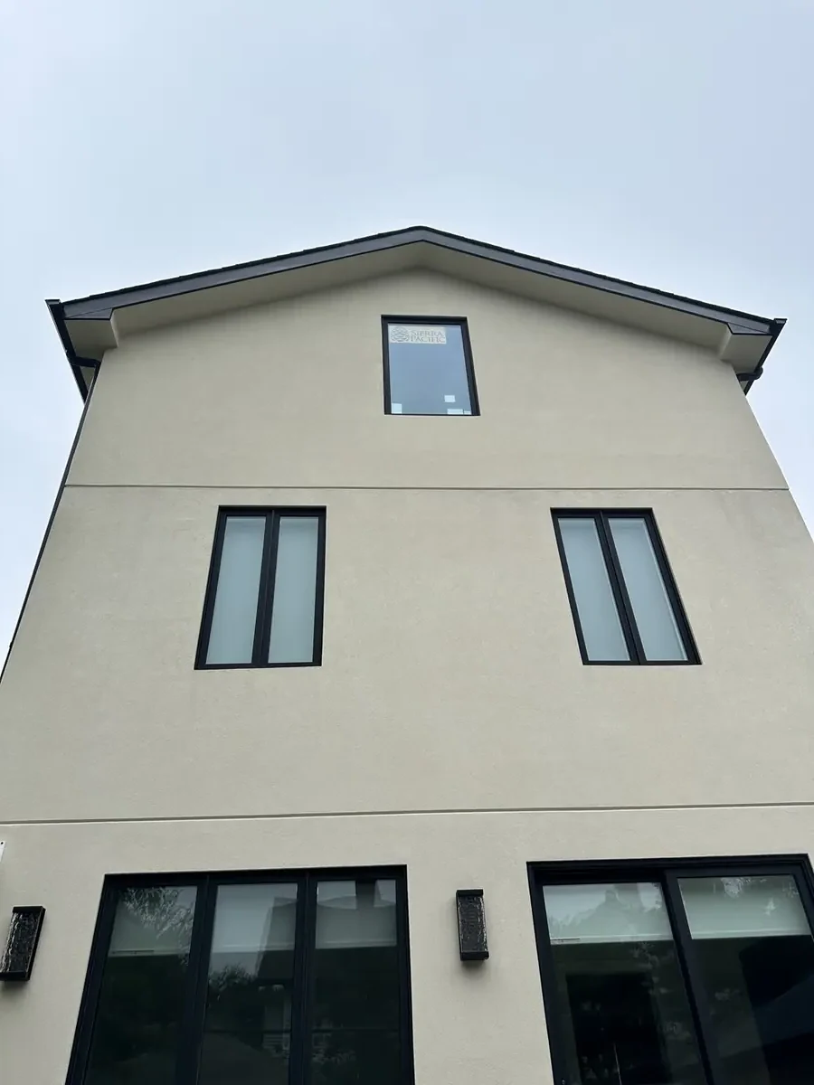 Finished stucco facade in Brooklyn with clean reveal lines and flashed window openings