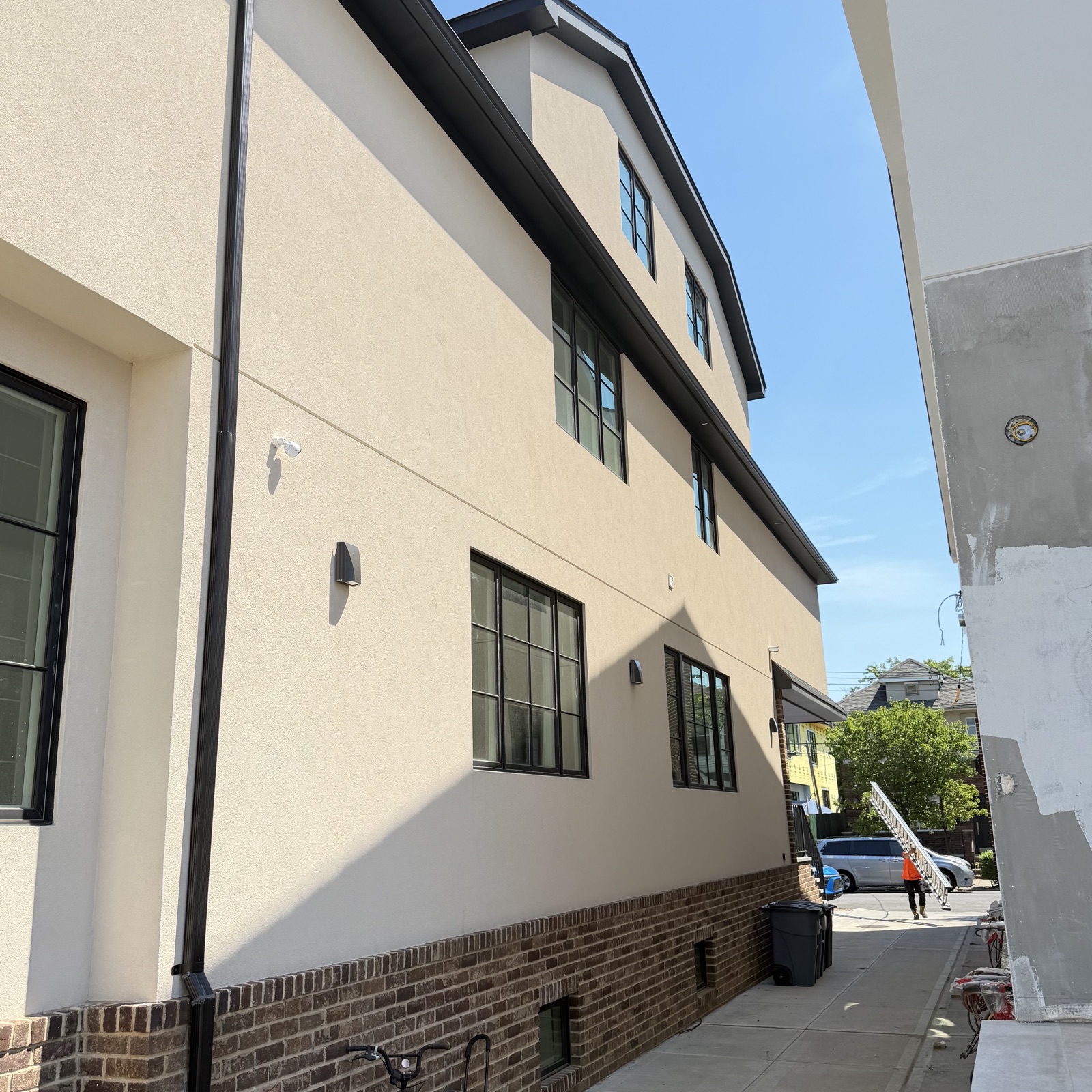 Waterproofing layer being applied to a Brooklyn wall before the stucco system goes on